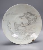 A Chinese porcelain dish engraved with horses, rocks and pine, diameter 33.5cm