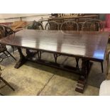 An 18th century style oak refectory table having planked top on double turned end supports, width