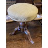 A Victorian revolving mahogany adjustable piano stool