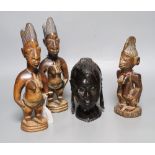 Three Yoruba figural carvings and a carved ebony head, tallest 27cm