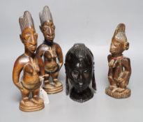 Three Yoruba figural carvings and a carved ebony head, tallest 27cm