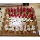 A 19th century Cantonese ivory chess and draught set, with later wood chess board and display