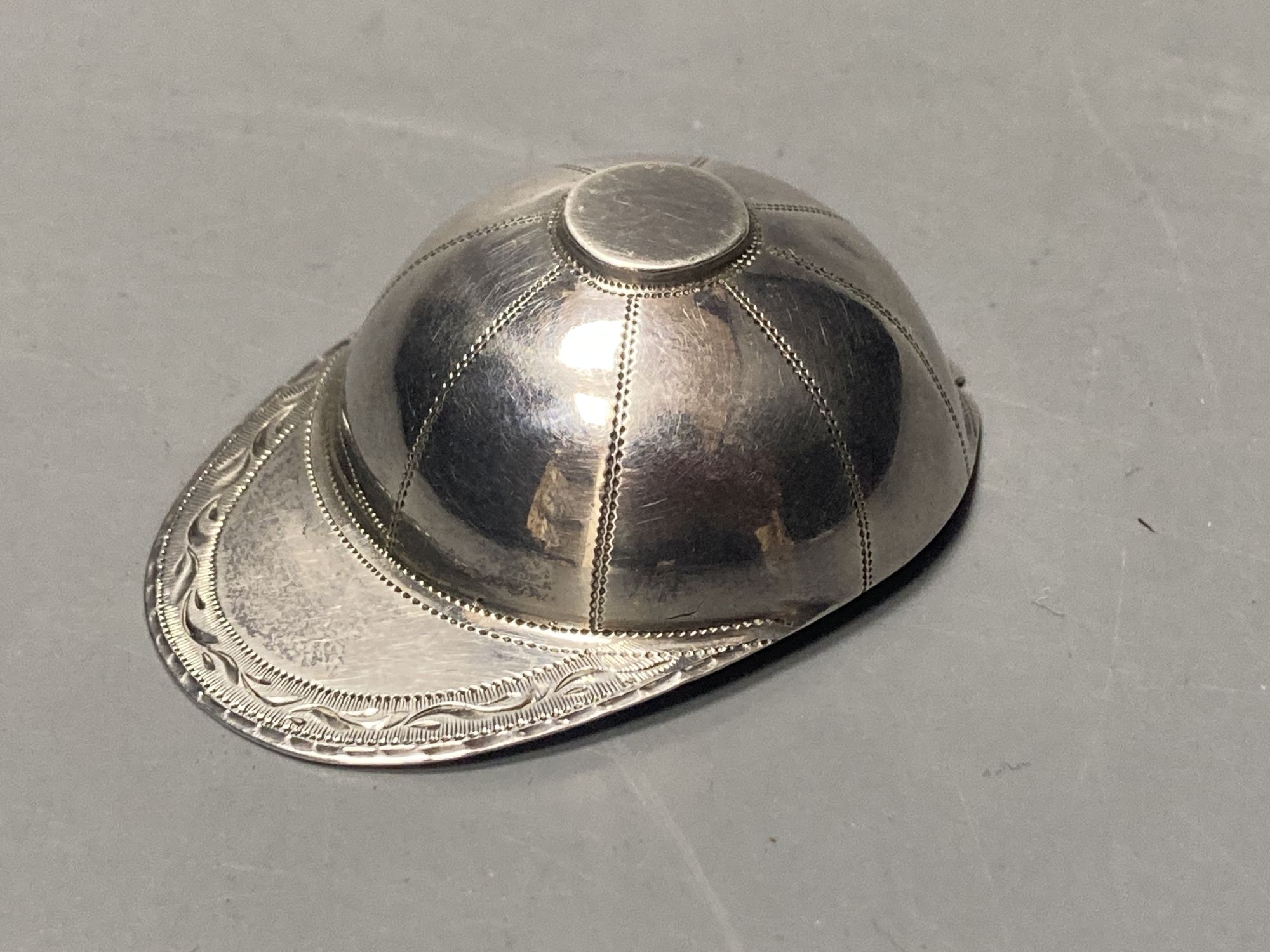 A George III engraved silver novelty caddy spoon, modelled as a jockey's cap, Josiah Snatt,