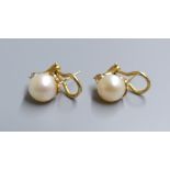 A modern pair of 14k, cultured pearl and diamond set earclips, gross 5.1 grams, pearl diameter 8.