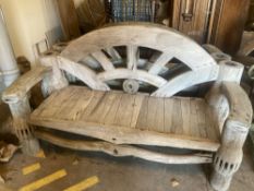 A pair of weathered hardwood cartwheel and hub garden benches, width 184cm depth 75cm height 105cm