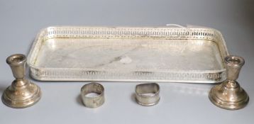 A plated tray, a pair of silver dwarf candlesticks and two napkin rings