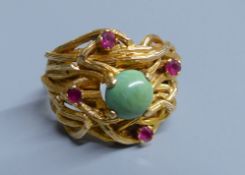 An 18ct, four stone ruby and single stone turquoise set rustic modernist cluster ring, size O, gross