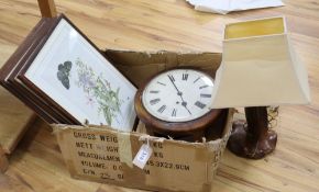 A dial clock, a carved wood table lamp and four prints