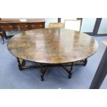 A late 17th century style oak oval topped, double gate leg dining table, width 214cm depth 180cm (