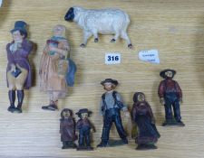 A group of American? painted cast iron and metal Amish figures, sheep money box etc.