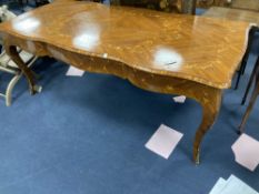 A Louis XVI design marquetry inlaid kingwood serpentine centre table, width 196cm depth 90cm