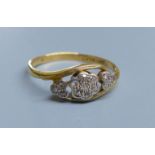 A 1940's? 18ct, plat and diamond set heart and flower head shaped triple cluster crossover ring,