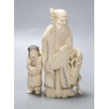 A Japanese ivory group of a man and deer, Meiji period, height 13cm,