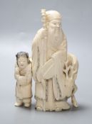 A Japanese ivory group of a man and deer, Meiji period, height 13cm,