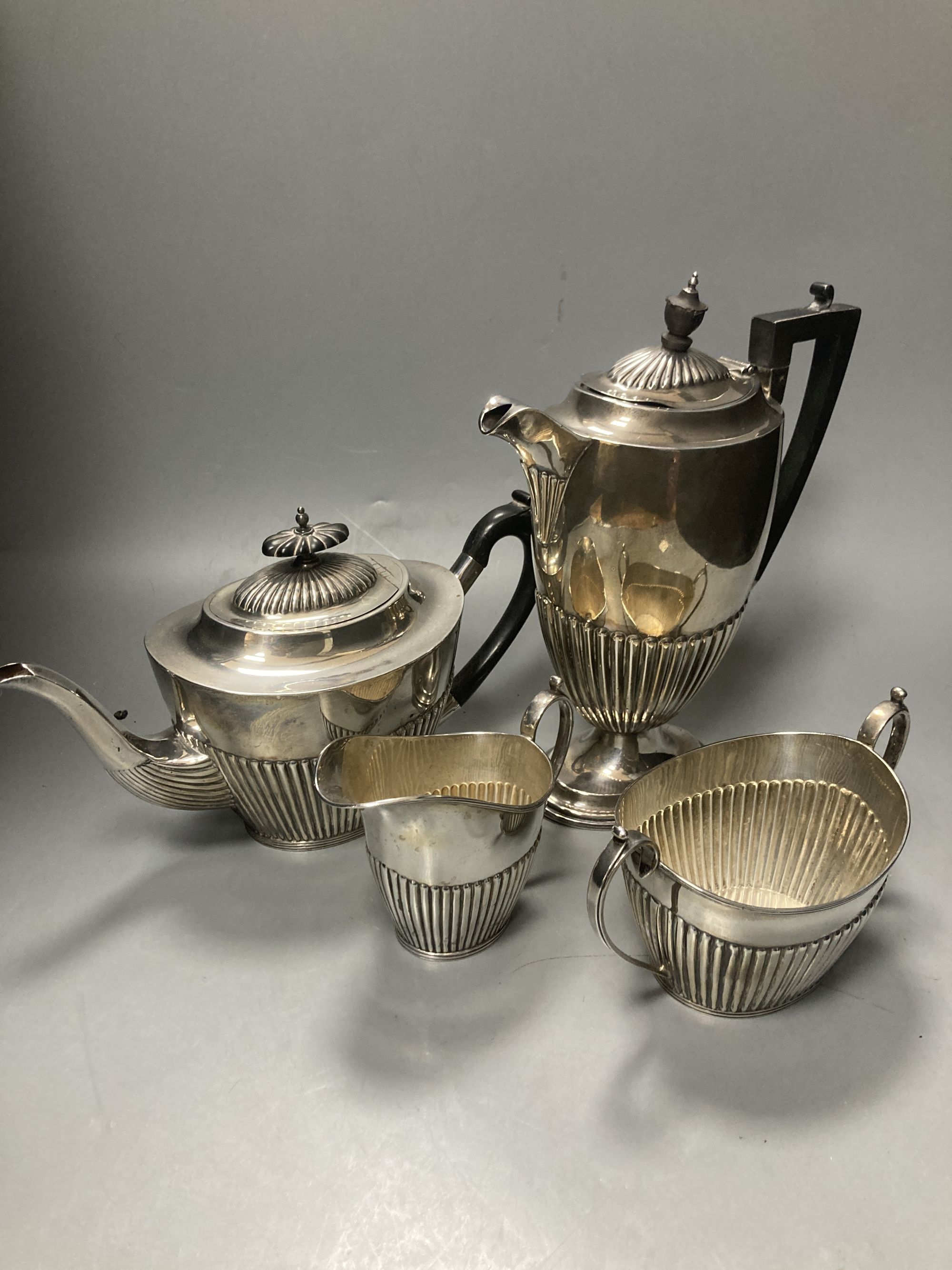 A late Victorian demi fluted silver three piece tea set, Mappin & Webb, Sheffield, 1897 & a