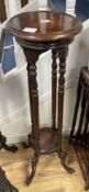 A mahogany two tier jardiniere stand, diameter 28cm height 100cm