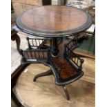 A Victorian ebonised and gilt thuya book table, the circular top over revolving trefoil book rack