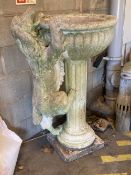 A reconstituted stone garden fountain modelled as a hound drinking from a circular bowl, width