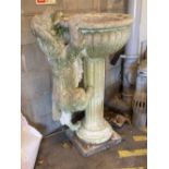 A reconstituted stone garden fountain modelled as a hound drinking from a circular bowl, width