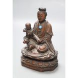 A 19th century Chinese wood group of Guanyin and a child, height 13cmCONDITION: Provenance -