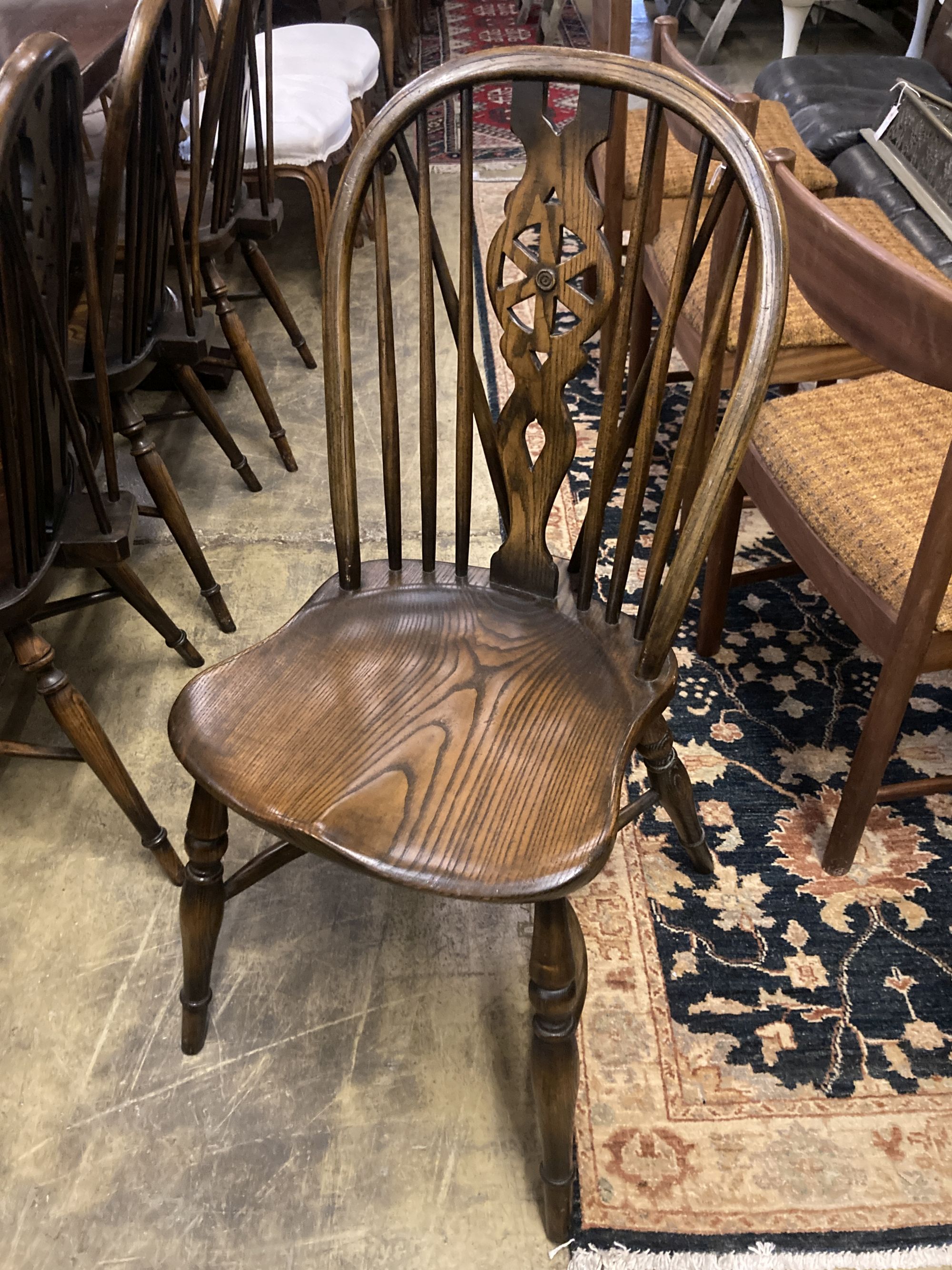 A set of ten stained ash and elm Windsor chairs with crinoline stretchers (two having arms) - Image 4 of 6