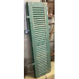 A painted wooden shutter, each panel 46 x 169cm