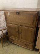An Ercol elm drinks cabinet, fitted fall flap over cupboards and drawer, width 82cm depth 44cm