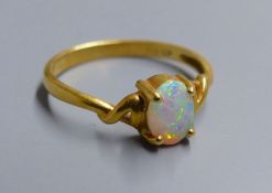 An 18k and single stone white opal ring, size O, gross 2.5 grams.CONDITION: Some minor surface