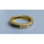 A modern yellow metal (tests as 18ct), sapphire and diamond set full eternity ring, size 0, gross