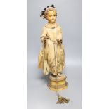 A late 19th century Continental carved and painted wood statue of a Saint, on a plinth base,