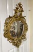 A giltwood convex wall mirror, length 90cm