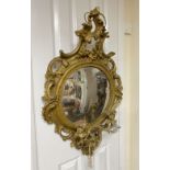 A giltwood convex wall mirror, length 90cm