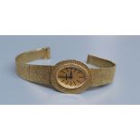 A lady's 9ct gold Bueche Girod manual wind wrist watch, on a textured 9ct gold bracelet, 15.7cm,