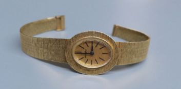 A lady's 9ct gold Bueche Girod manual wind wrist watch, on a textured 9ct gold bracelet, 15.7cm,