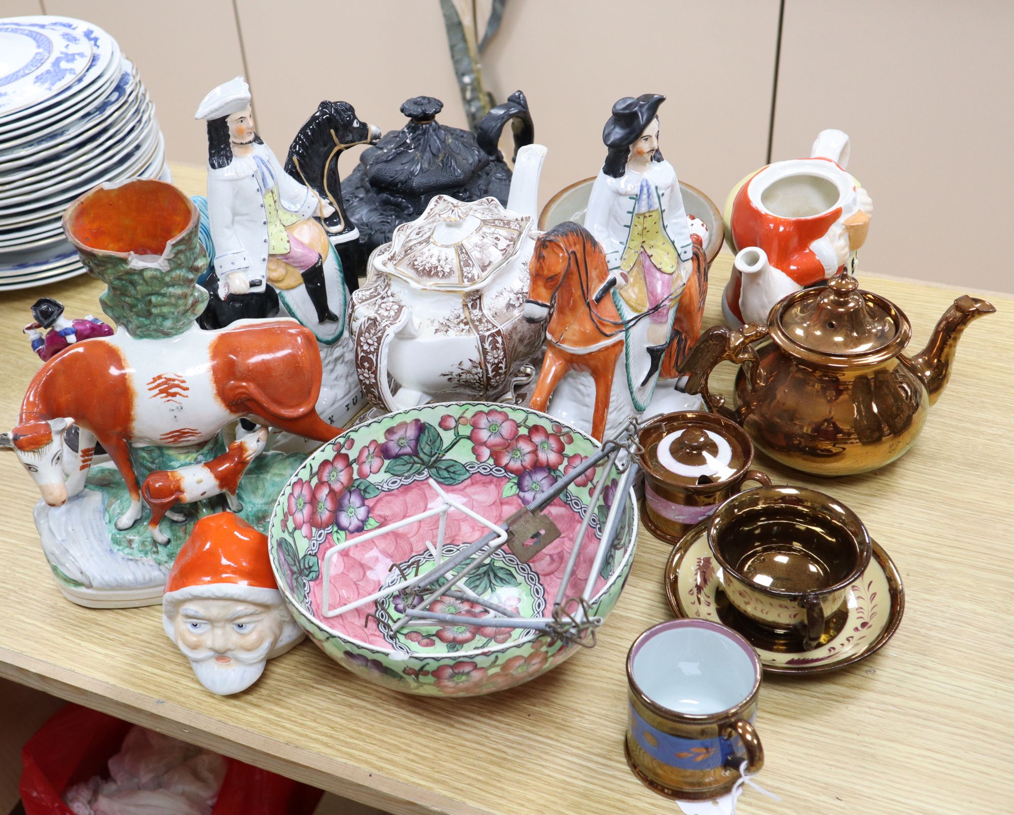 A group of Staffordshire pottery figures, teapots and lustre wares