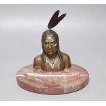 A bronze and marble 'Native American' desk stand, height 19.5cmCONDITION: Part of the cigarette in