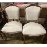 A pair of Louis XV style carved walnut side chairs