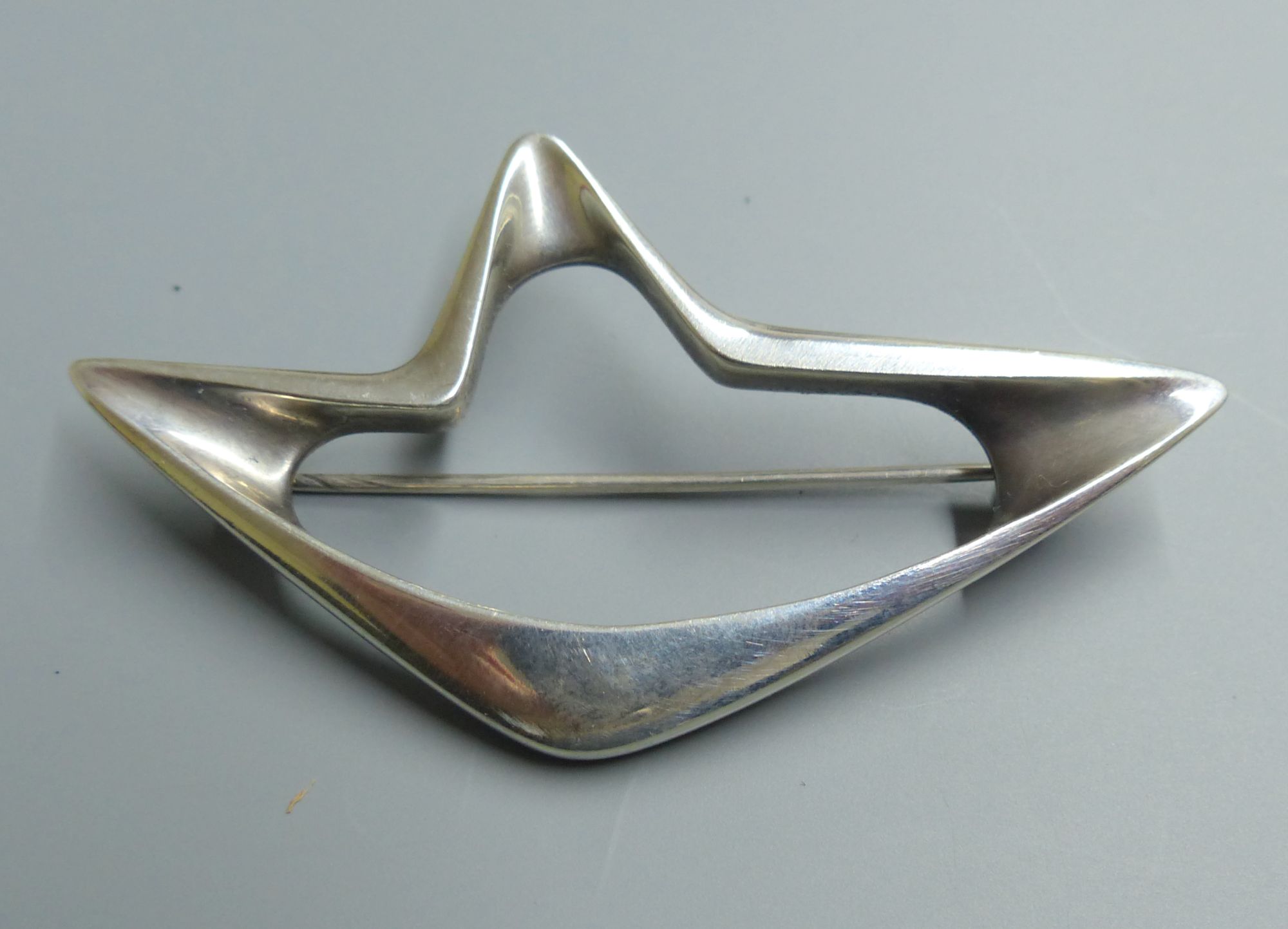 A Georg Jensen sterling abstract brooch, designed by Henning Koppel, no. 376, 67mm.CONDITION: