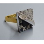 An unusual white metal, black onyx?, sapphire and diamond set square cluster ring, with planished '