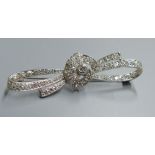 A white metal and millegrain set diamond cluster ribbon bow brooch, 54mm, gross 5.9 grams.CONDITION: