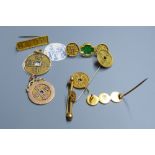 Eight assorted Chinese yellow metal amulets, four in the form of brooches, three pendants and a