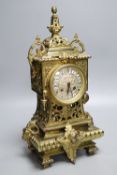 A French brass rococo-style mantel clock, with key and pendulum