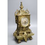 A French brass rococo-style mantel clock, with key and pendulum