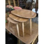 An Ercol nest of three 'Pebble' tables, width 64cm depth 42cm height 40cm