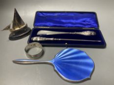 A cased silver handled button hook and shoe horn, a silver and enamel hand mirror, a silver bangle