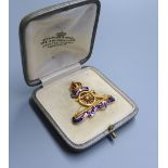 A cased early 20th century 15ct and four colour enamel Royal Artillery sweethearts brooch, width