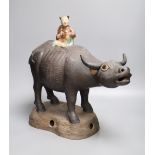 A large Chinese pottery group of a man riding an ox, Guandong kilns, height 40cmCONDITION: