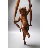 A late 19th century hanging wooden cherub