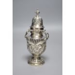 An ornate late Victorian silver sugar castor by William Comyns, London, 1897, 16.2cm, 7oz.CONDITION: