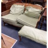 A 1920's mahogany framed three piece Bergere suite, together with a stool